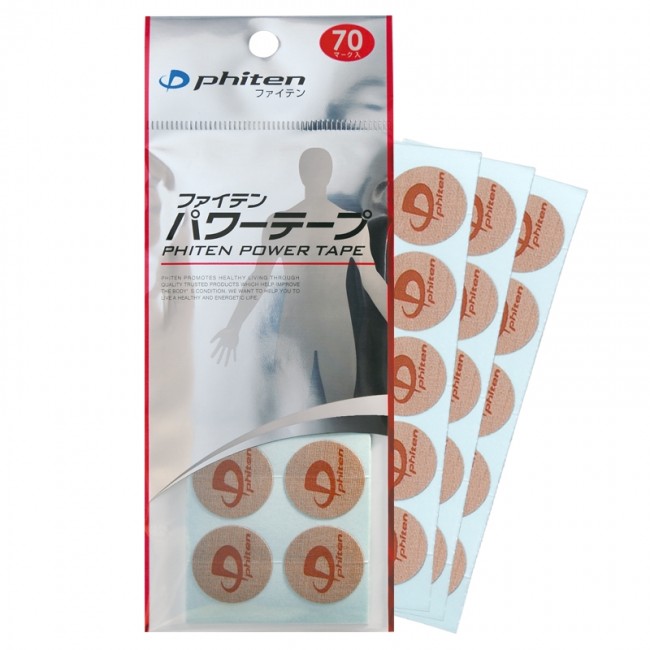 Vertical silver packaging for ‘Phiten’ Power Tapes with Japanese text and ‘Phiten POWER TAPE’. Body silhouette. Red circle with 70. Beside it, three round, skin-coloured Titan Ban Tapes with the ‘Phiten’ logo on white backing paper.