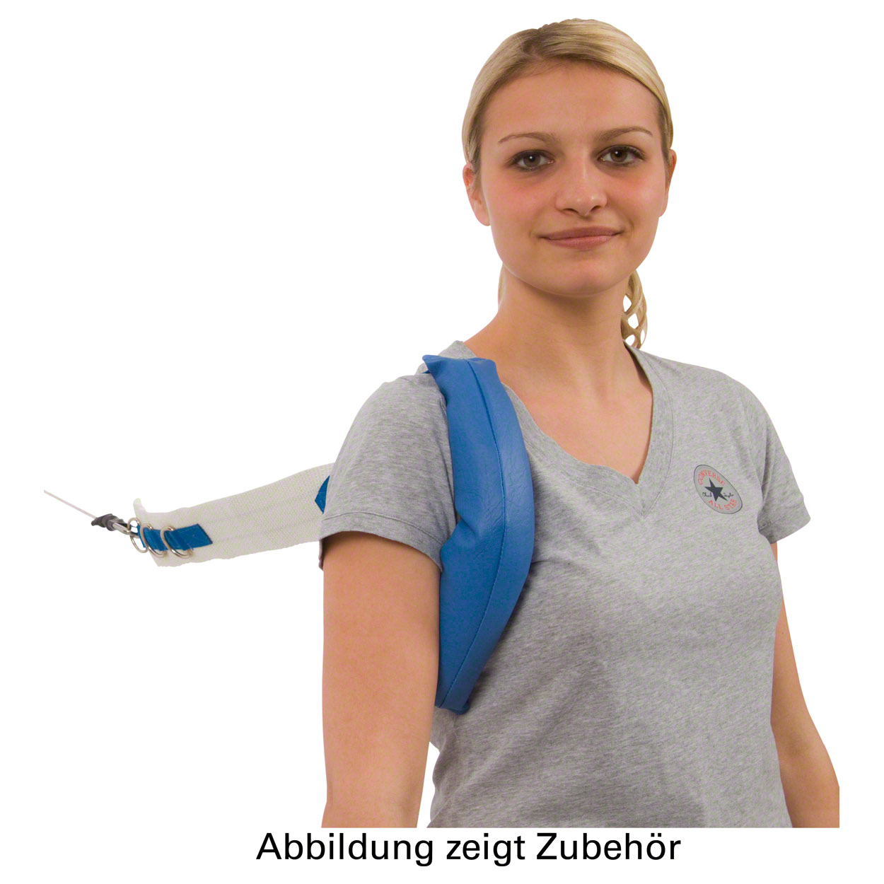 A young blonde woman in a grey T-shirt is modelling a blue, padded cable pulley strap. It is draped over her right shoulder; a white strap with metal eyelets and a carabiner is attached by a cable, for shoulder exercises or physiotherapy.