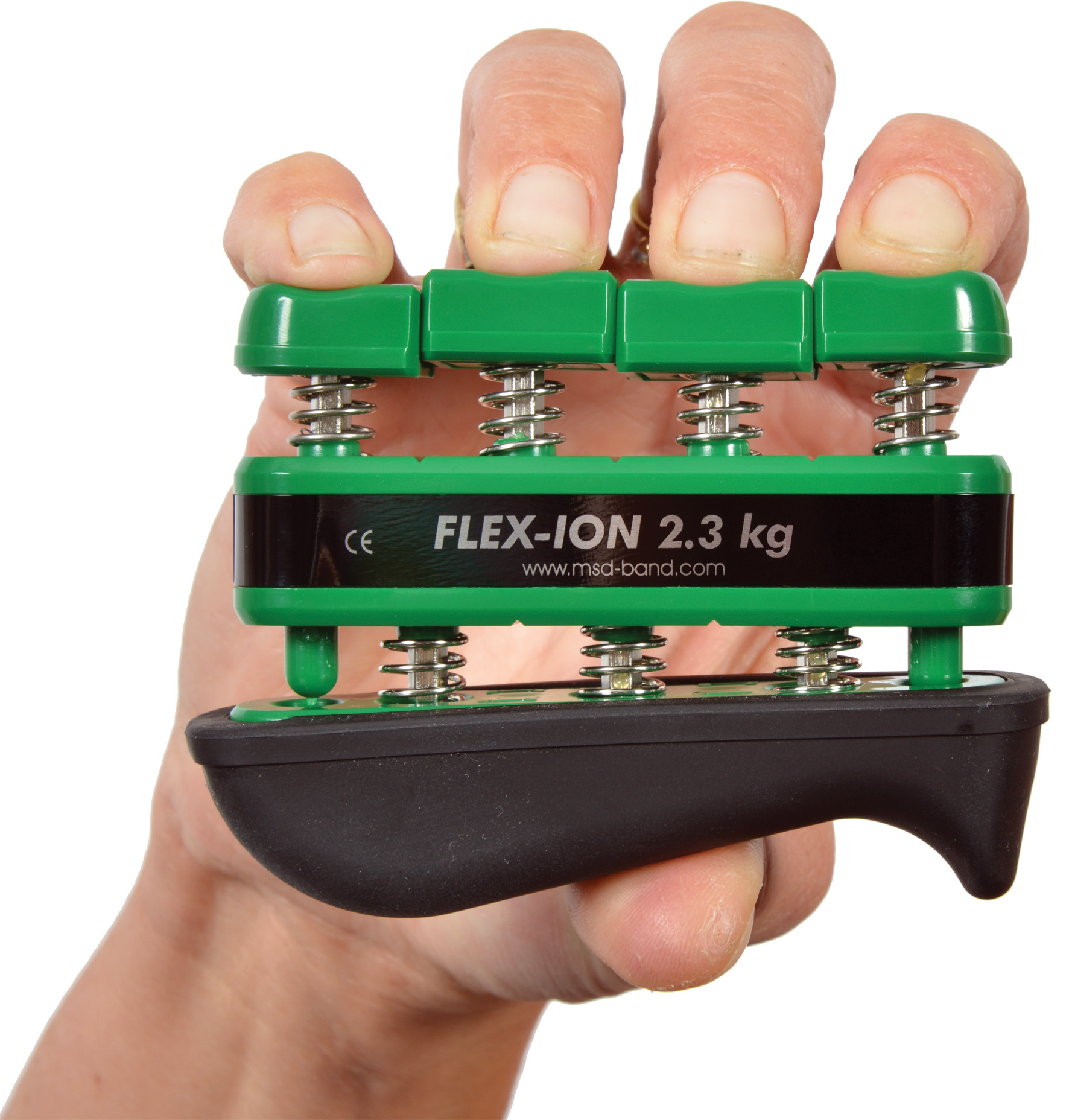A hand is holding a green and black Flex-Ion hand trainer. The fingers are pressing spring-loaded buttons to build strength. The inscription ‘FLEX-ION 2.3 kg’ is visible, indicating the resistance level.