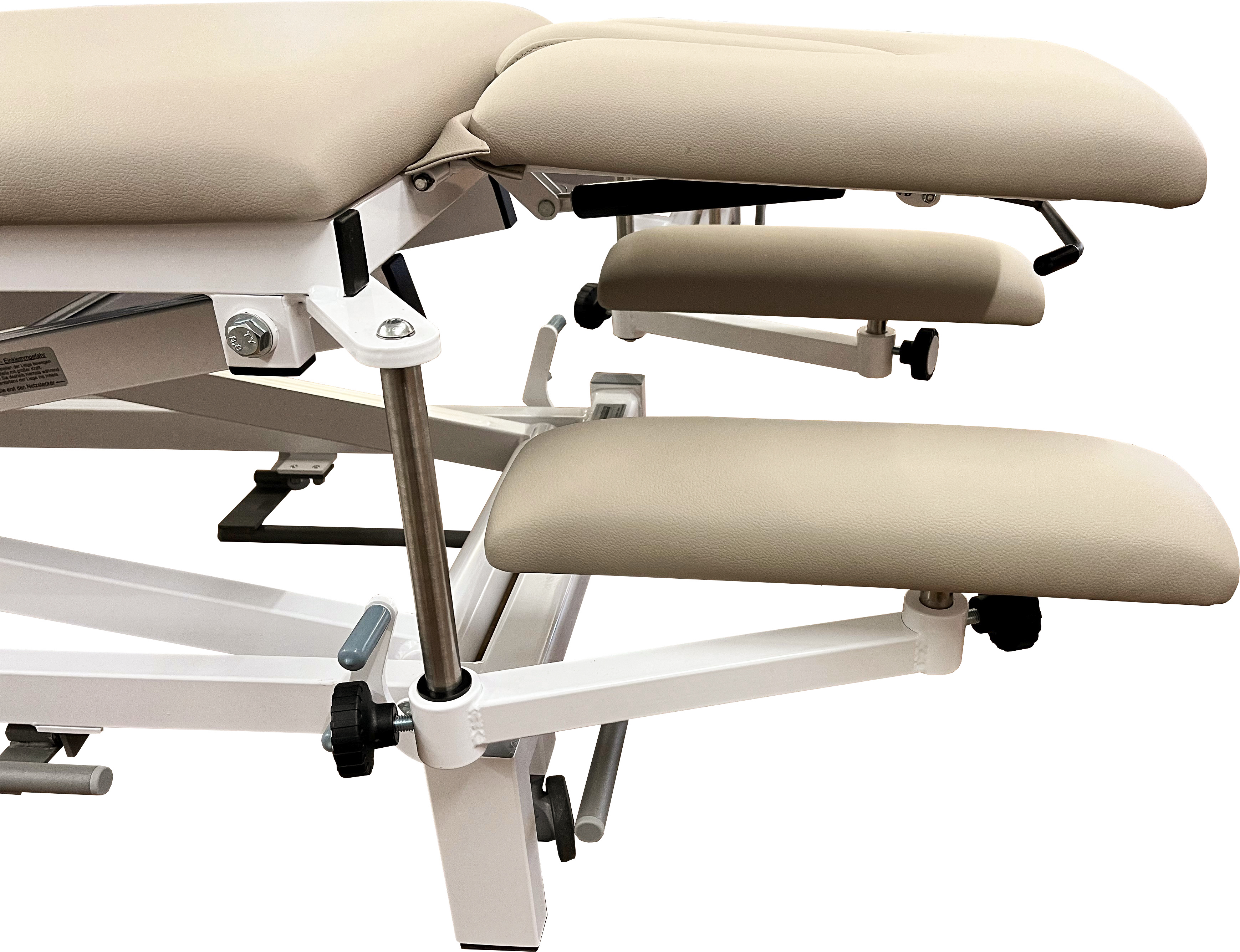 A light-coloured, upholstered treatment couch in beige with adjustable armrests and a sturdy white metal frame. The upholstery features a fine, faux-leather-like texture. Adjustment knobs and levers for custom positioning, ideal for medical practices.