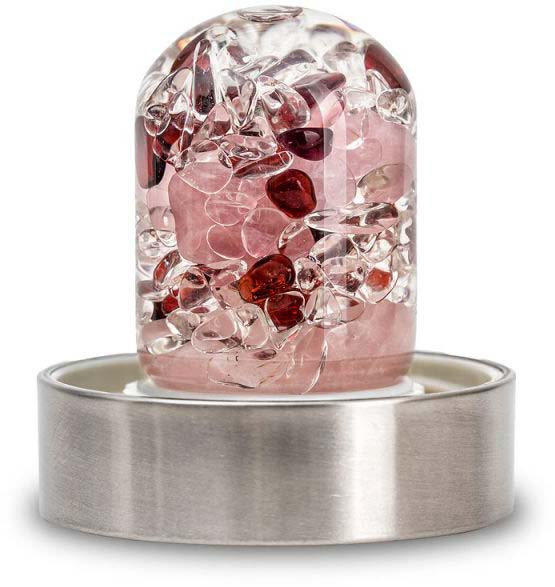 Transparent ‘Wellness’ gemstone insert for water bottles, filled with a revitalising blend of gemstones. Polished rose quartz, rock crystal and amethyst are visible. Cylindrical glass body with a stainless steel ring for attachment.