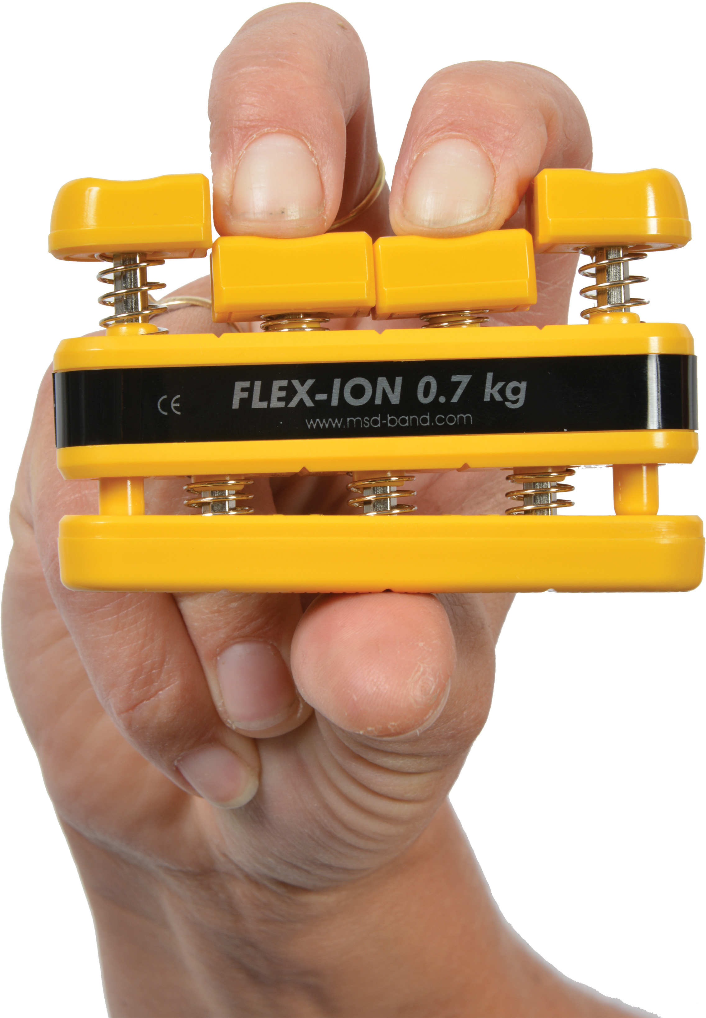 A hand is holding a yellow Moves Flex-Ion hand trainer with four spring-loaded yellow buttons that are pressed by the fingers. The black centre section displays ‘FLEX-ION 0.7 kg’. For strengthening and rehabilitation of the fingers.