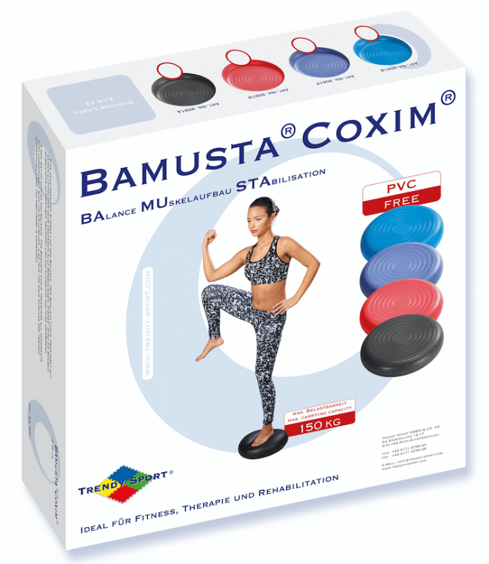 A sporty woman is balancing on a black, round Bamusta Coxim balance cushion with one knee raised. Also shown are balance cushions in red, blue and black, designed to improve balance, coordination and muscle development.